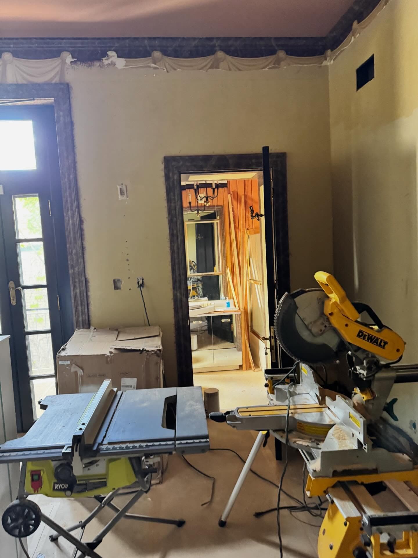 Work room with table saw and miter saw set up during a project